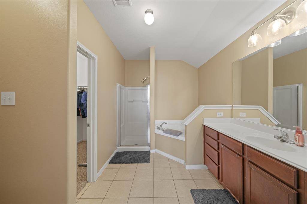 The Spacious Primary Bath Suite has a Large Walk-in Closet, Separate Shower and Soaking Tub.