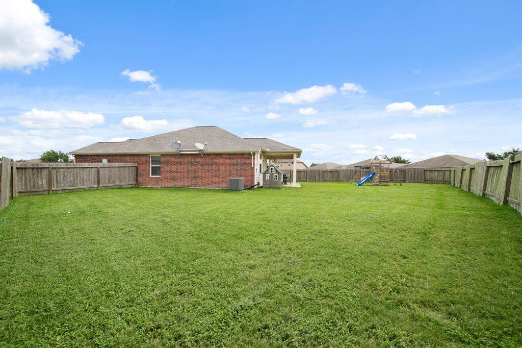 This Oversized Backyard still has Ample Green Space for Kids and Four-legged Family Members to Run and Play.