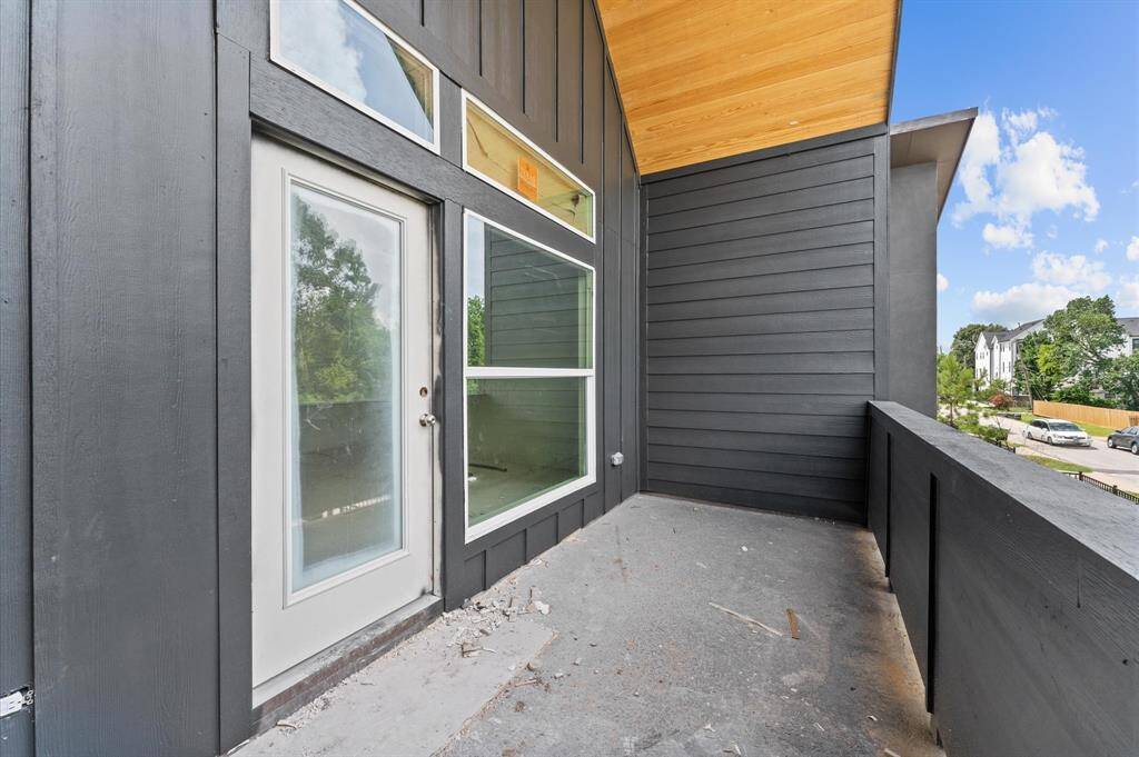 Spacious primary bedroom with cathedral ceilings and balcony. *Photos taken in early June*
