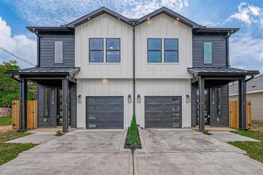 Modern duplex with a sleek design featuring contrasting dark and light exteriors. Each unit has its own garage, covered entryway, and large windows for natural light. Ideal for contemporary living.
