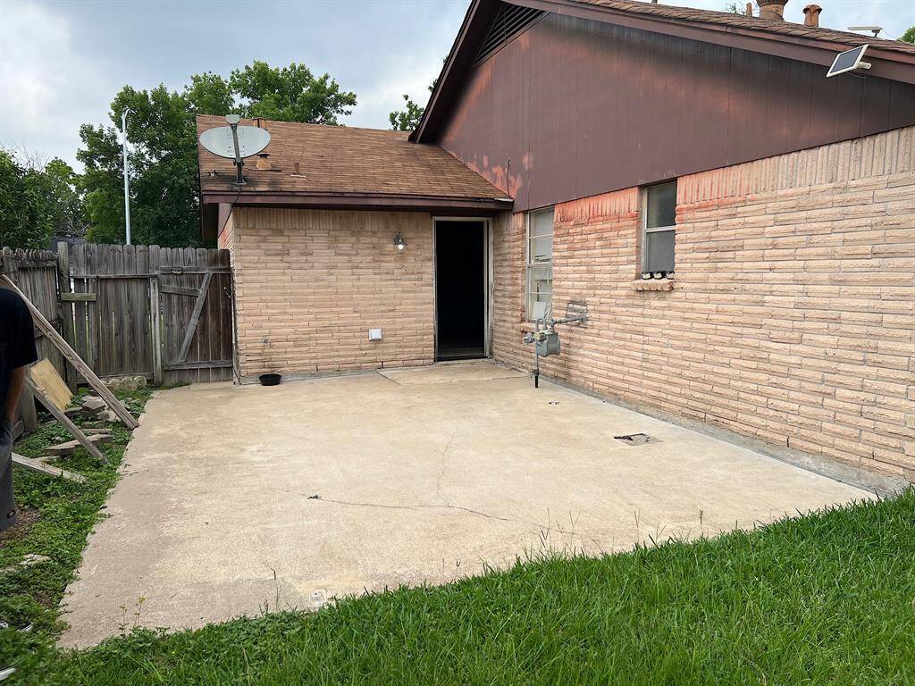 Large concrete patio pad outside the back door.