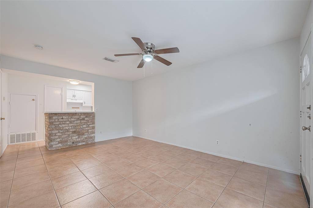 The living room is open to the kitchen with a gorgeous brick bar between the two spaces!