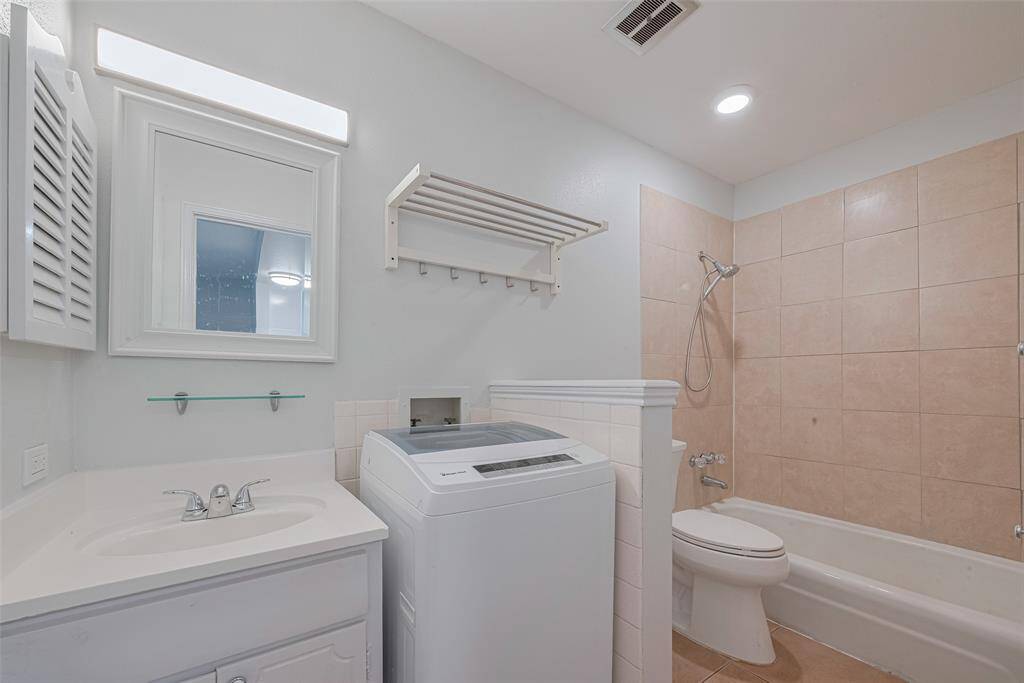 The bathroom can be entered from the bedroom or the living area when guest are visiting.  The included washer is in the bathroom.