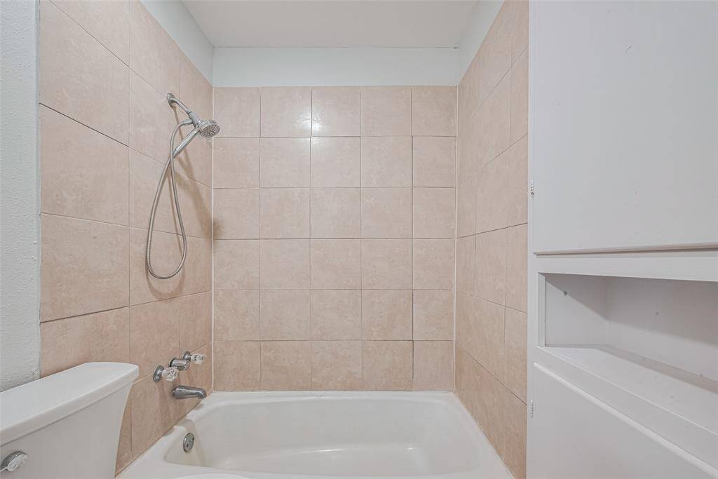 The bathroom has an abundance of cabinet space and also features an over size tub/shower combination.