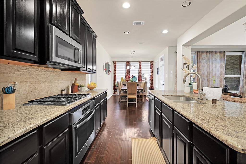 Extensive counter and cabinet space, stainless steel appliances and large pantry makes this a chef's dream kitchen