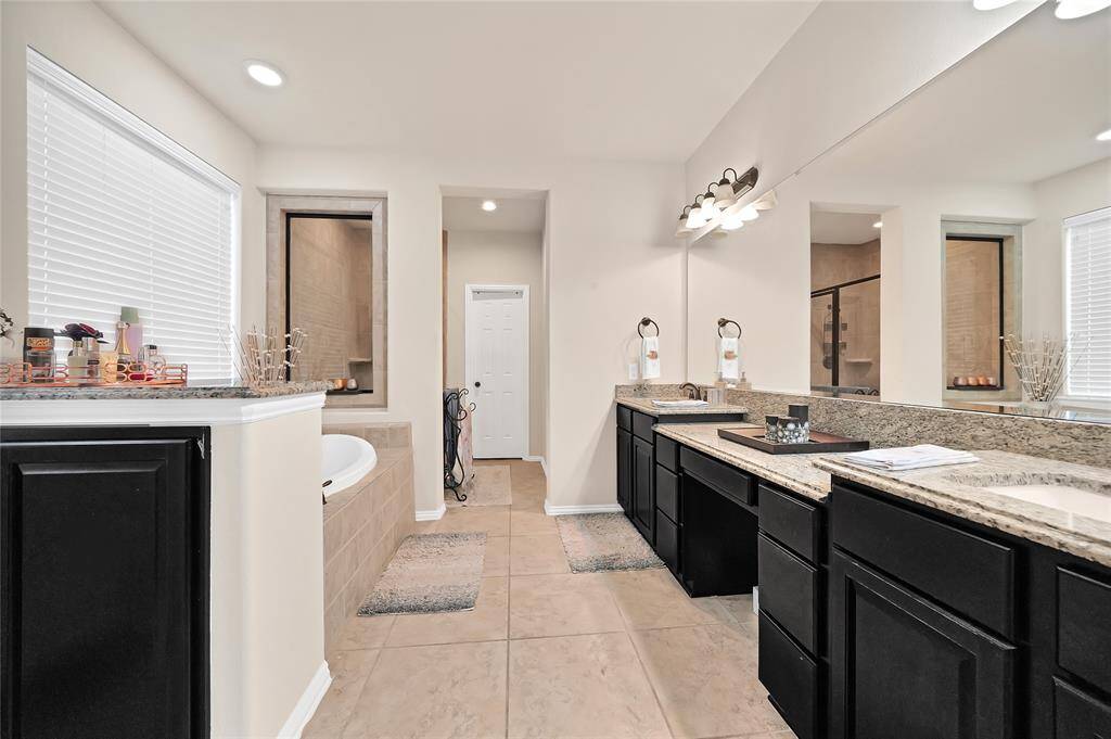 Primary Bath with double sink, walk in shower and a soaking tub.