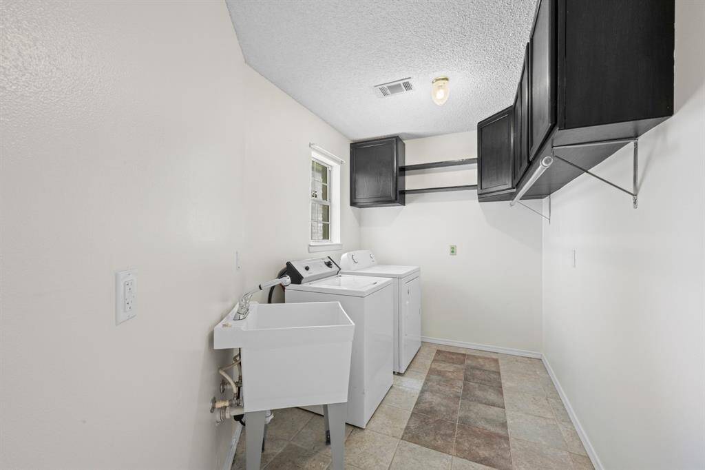 Utility room w washer, dryer and sink