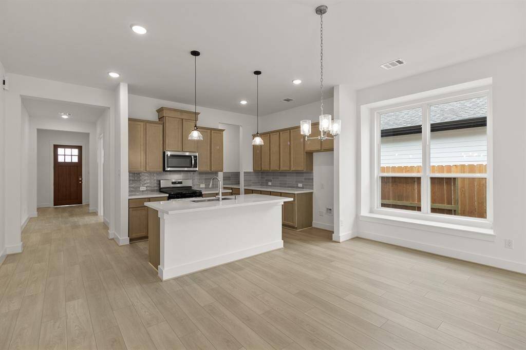 With its seamless layout, the kitchen flows effortlessly into the dining and living spaces, creating a perfect hub for family and friends to gather.
