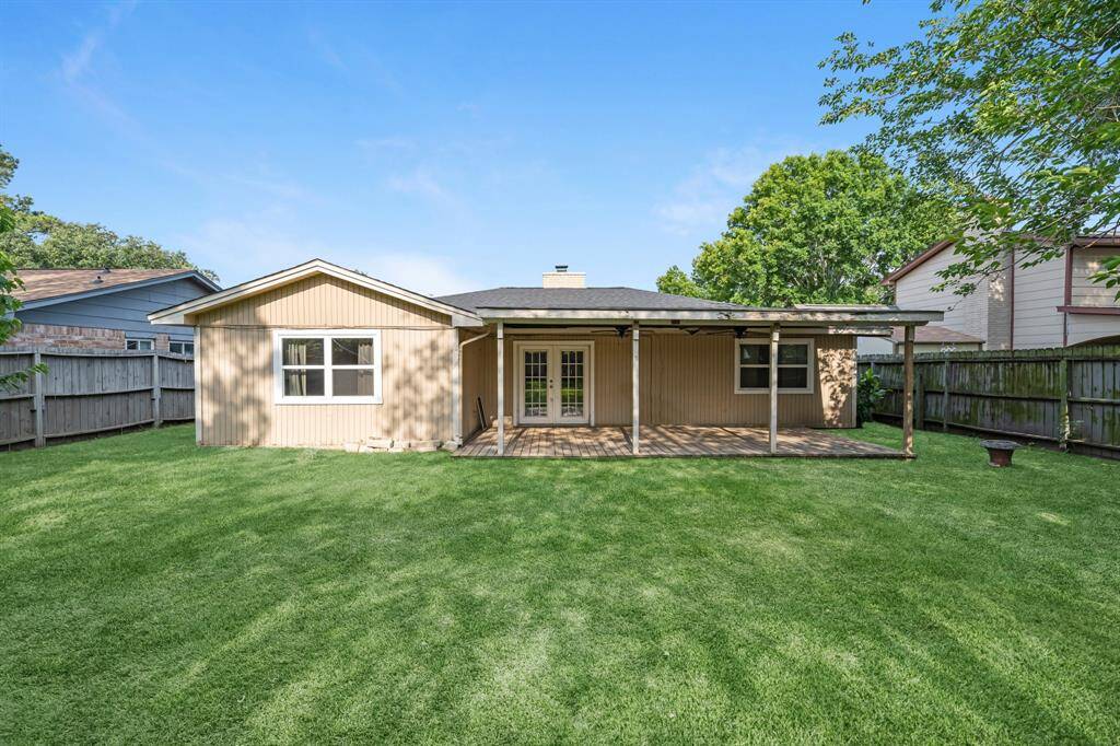 The covered patio is generously sized, providing ample space for various outdoor activities.