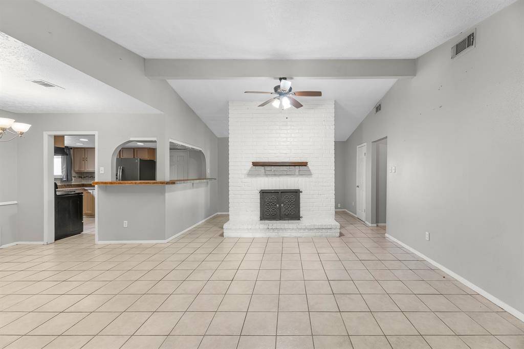 Cozy family room with a classic wood-burning fireplace—perfect for relaxing evenings and gathering with loved ones.