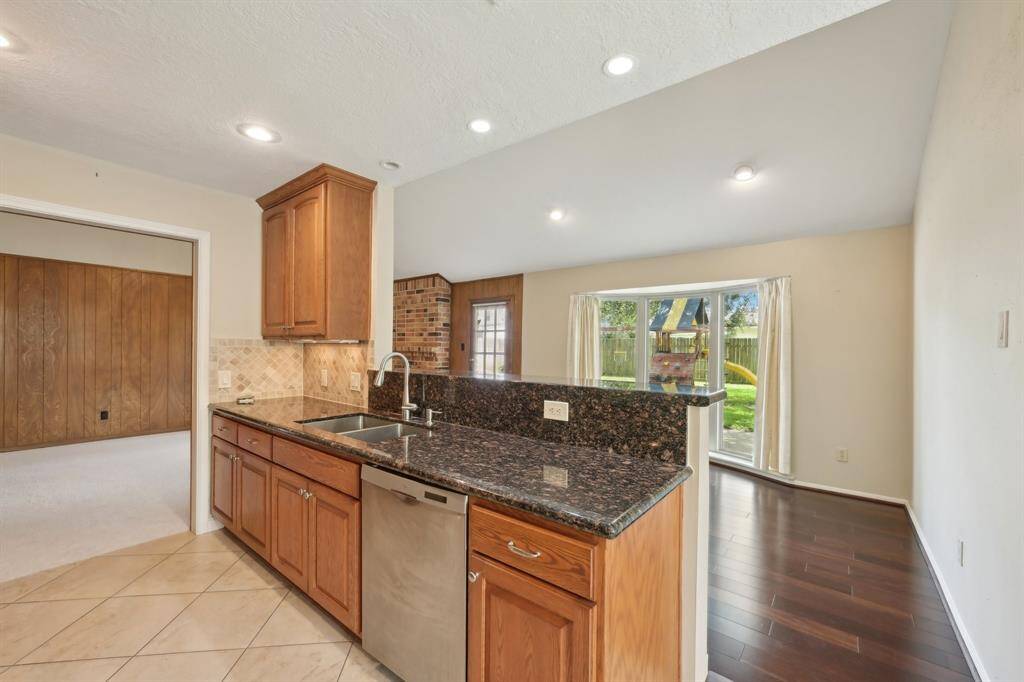 Attractive tile flooring laid on the diagonal is a great upgrade. Look at the view from the sink out to the patio.
