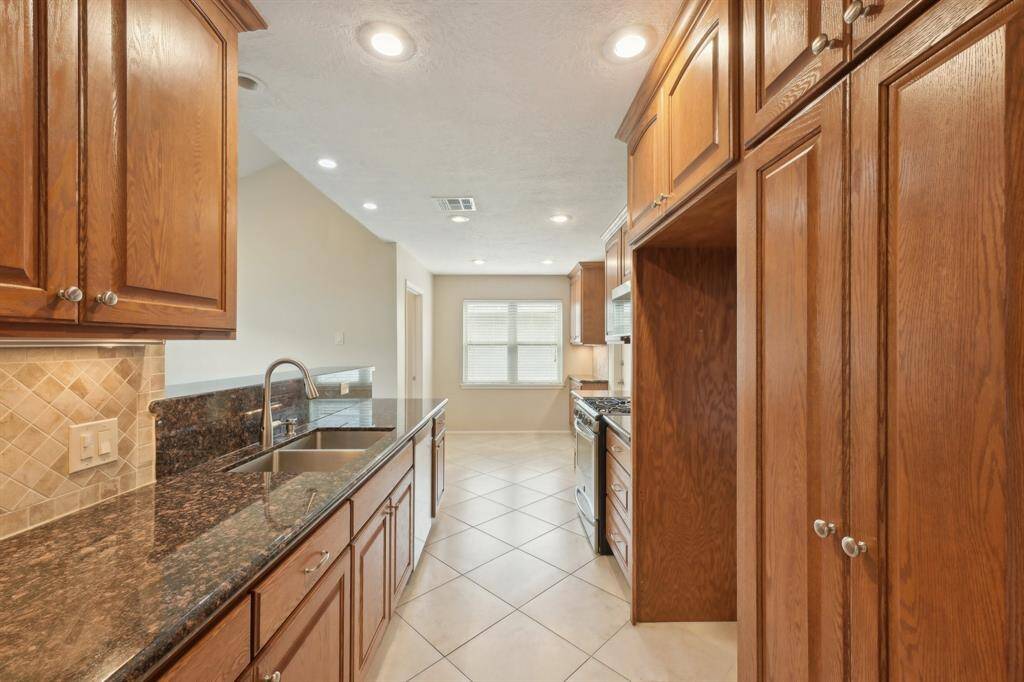 A clear view of the breakfast room at the end of the kitchen. Door on the left leads to the laundry center.