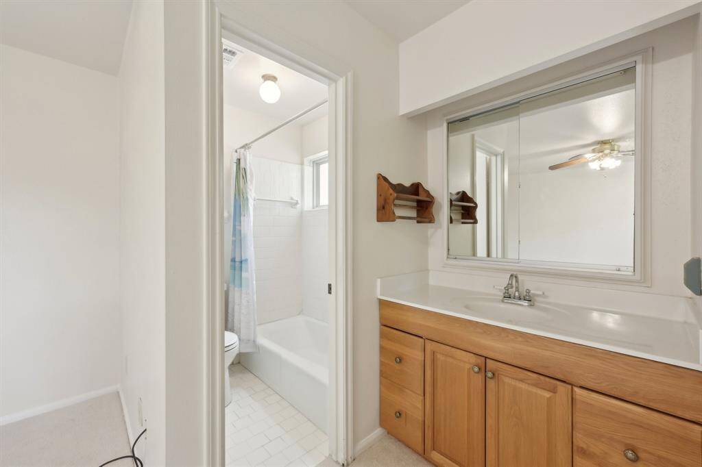Updated vanity area can be closed off from rest of bath for better privacy.