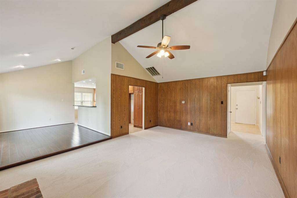 From the fireplace you can see into the other areas of the living space. Hall closet in the entry hall. Vaulted ceiling with rustic wood beam accent adds style. Recessed lighting a big plus.
