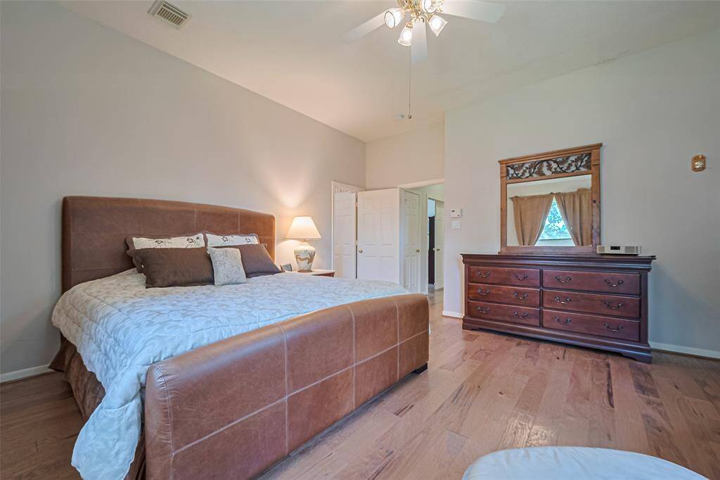 King-size leather bed with Simmons Beauty mattress (excellent condition) and dresser with mirror included in the primary bedroom