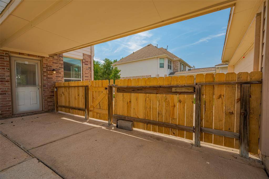 Backyard Entrance with wooden gate that opens two ways, individual door for personnel and larger gate-door.