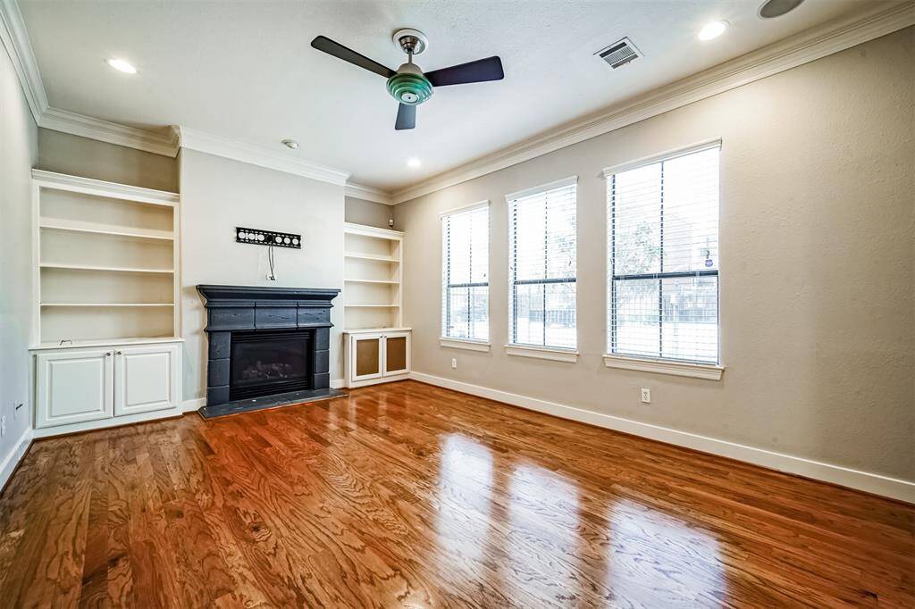 Beautiful welcoming entryway featuring a wooden staircase leading to the bedrooms. The space is highlighted by hardwood flooring and neutral color walls, offering a clean and airy feel.