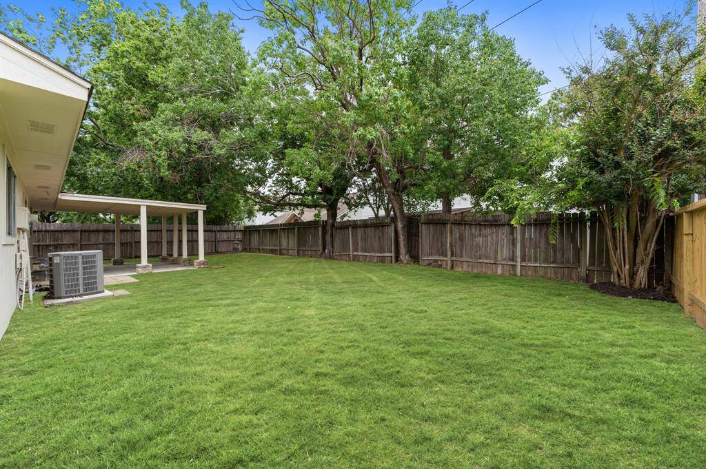 Large, fenced backyard with covered patio is perfect for entertaining.