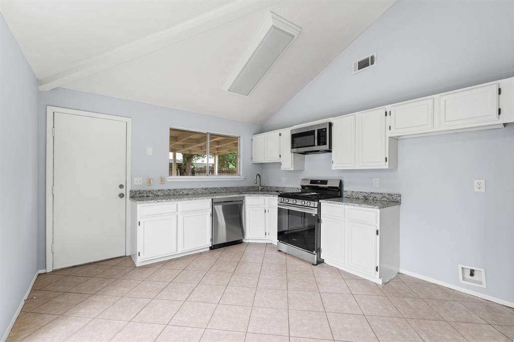 Granite countertops with new stainless steel appliances.