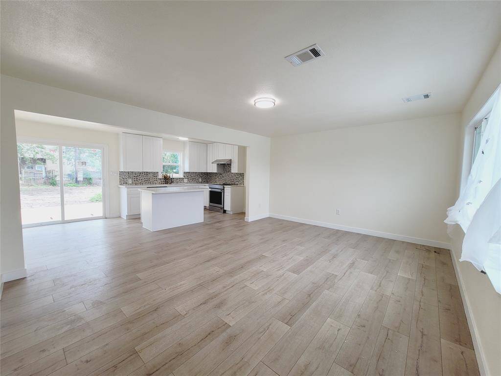 Living room open to kitchen and dining area