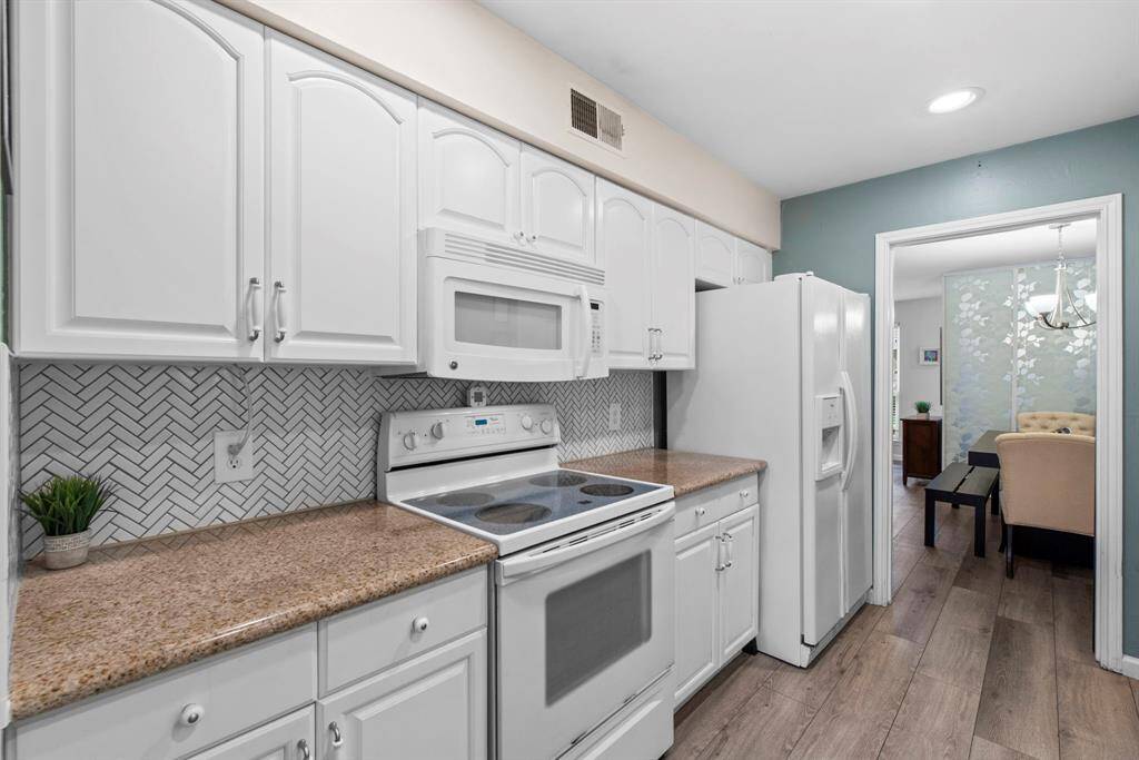 Practical and utilitarian kitchen with easy access to the formal dining room.