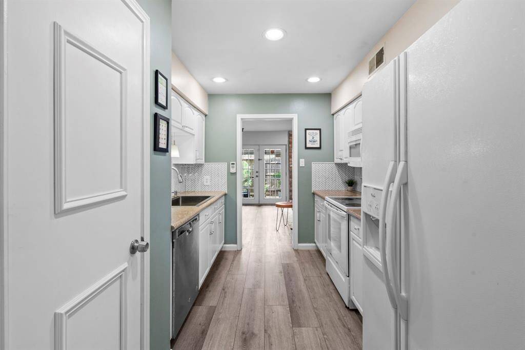 Perspective of the kitchen looking towards the family room and beyond to the patio.