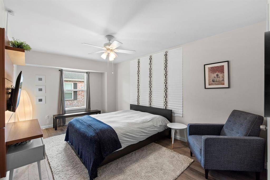 Bright and minimal, this secondary bedroom features clean lines, soft neutral walls, and a large window for natural light. A perfect guest or office space.