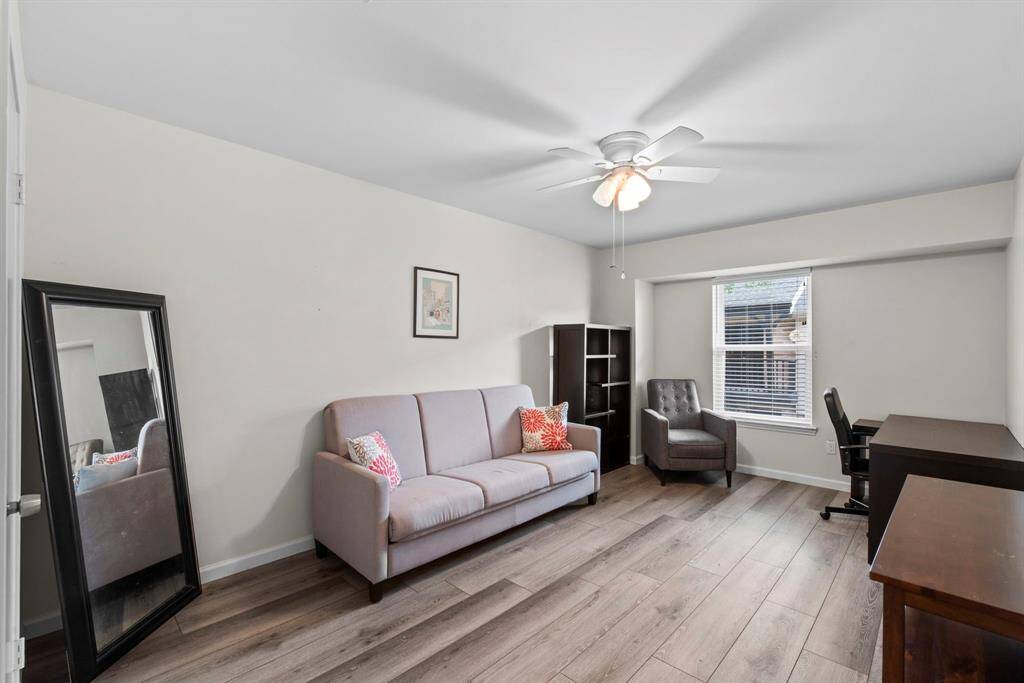 Flexible and spacious, this room is ideal for a guest suite or home office, with sleek floors, neutral tones, and a full window for natural light.