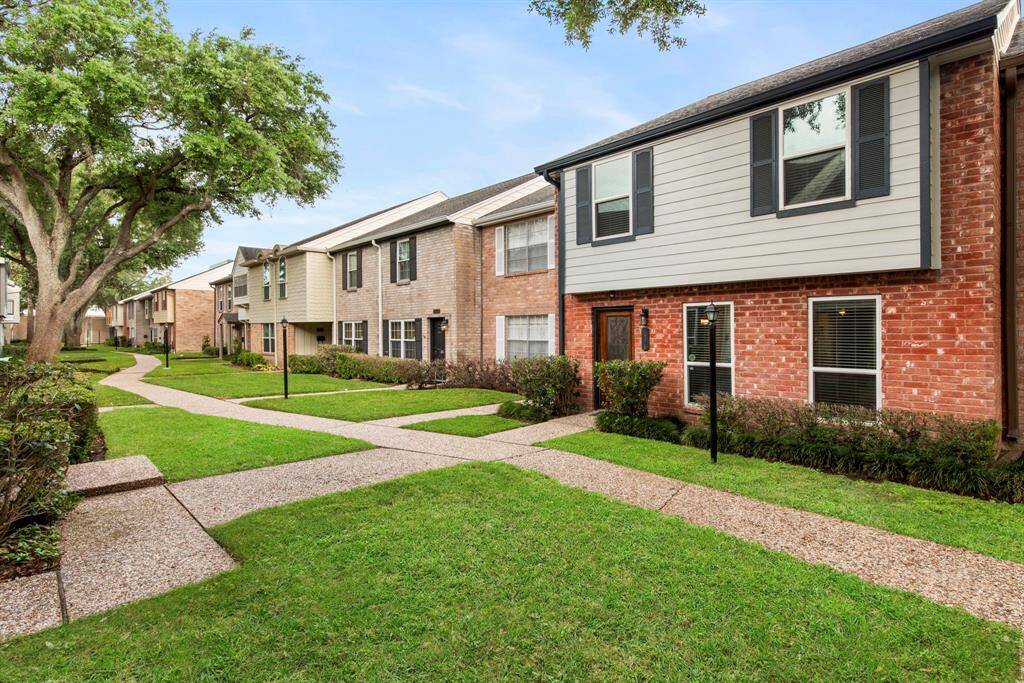 Tree-lined paths and manicured lawns create a peaceful, walkable neighborhood with classic townhome appeal.