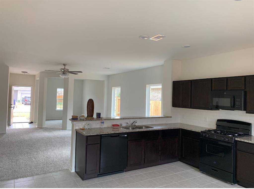 This photo showcases a spacious open-concept kitchen and living area.