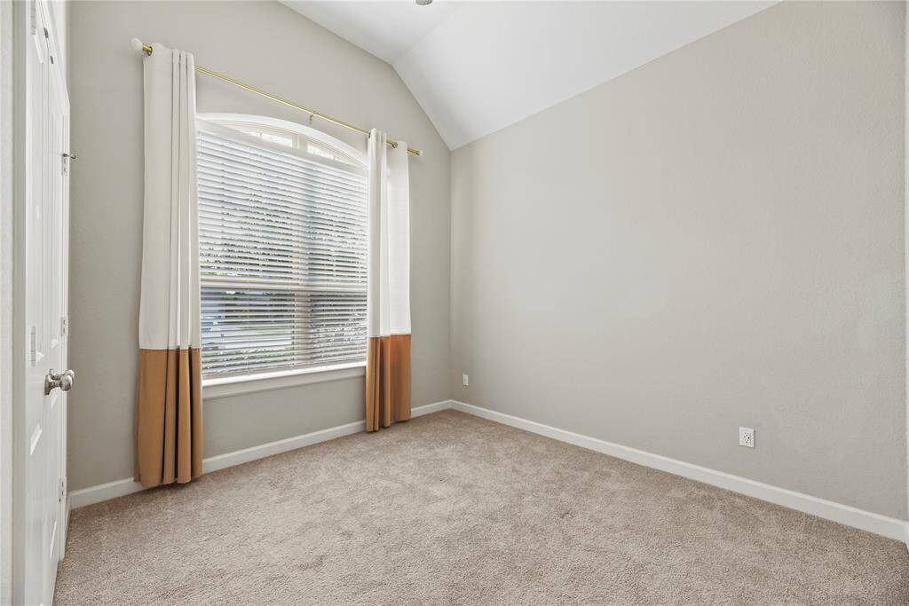 This is a second bedroom found on first floor and is filled with light, high ceilings and window treatments.