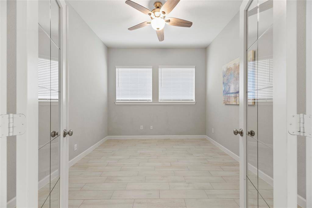 Dedicated study with French doors for privacy accented with plenty of natural light and a fan.