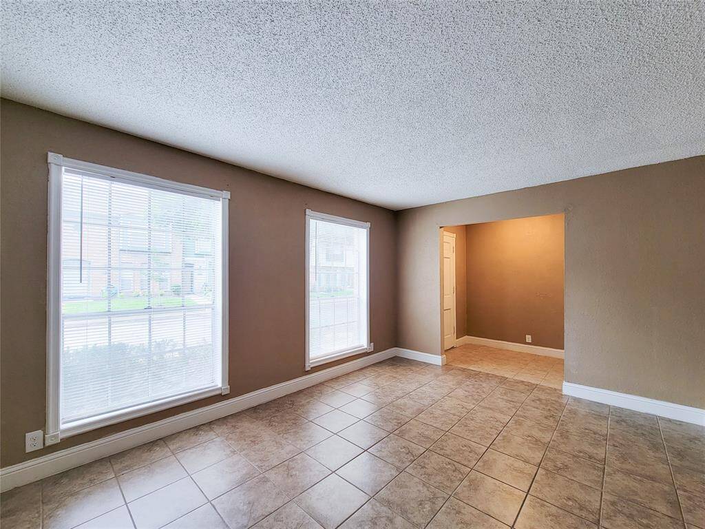 The oversized living room has lots of natural light. The powder room is right across from the front entry door.
