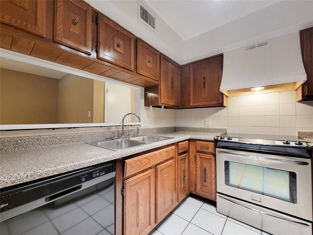 The kitchen has a pass through and the stainless steel refrigerator is included.