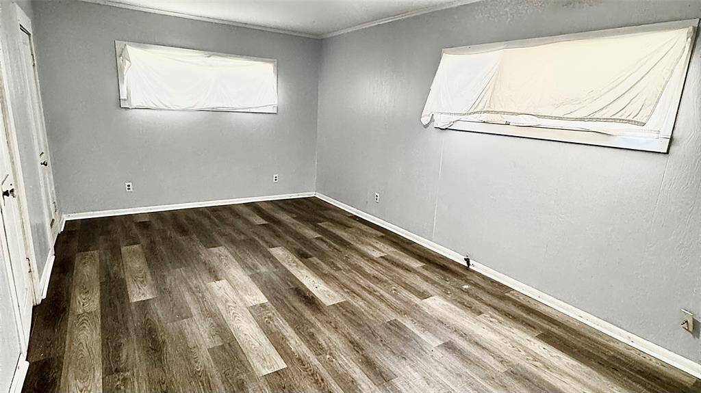 Primary bedroom with built in shelving and 2 closets