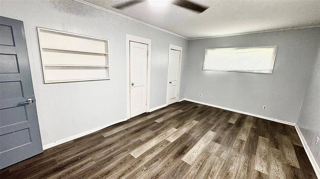 Primary bedroom with built in shelving and 2 closets