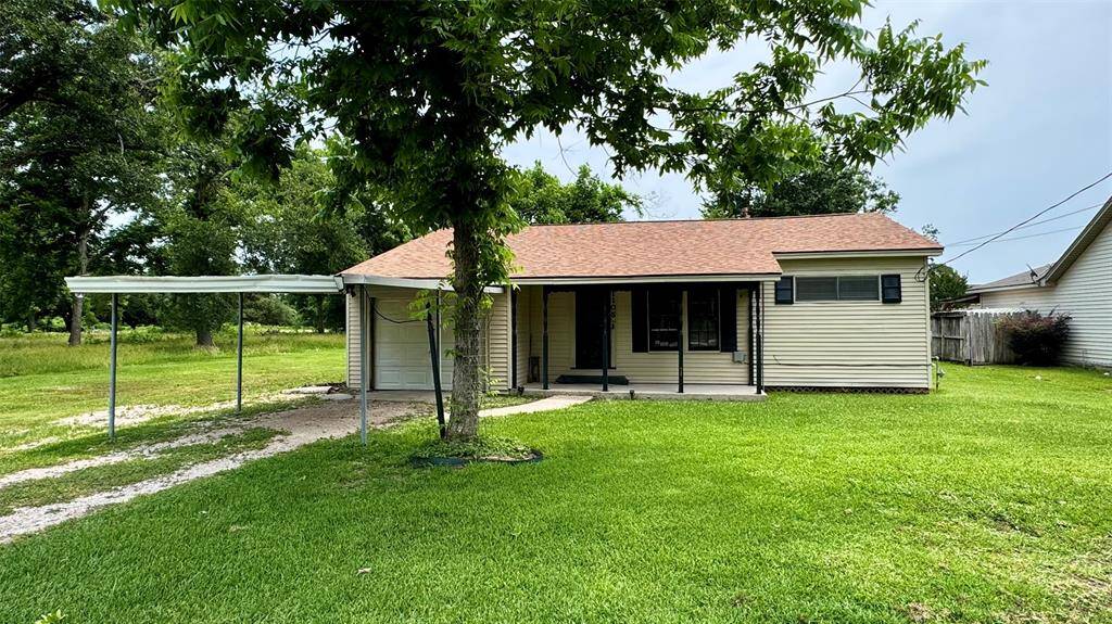 Front of home with front porch and carport