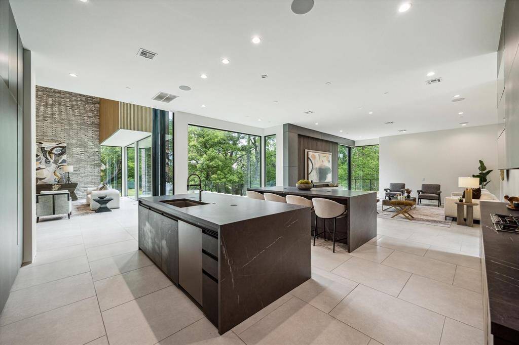 The kitchen seamlessly opens to both the family room and living room, creating a fluid and expansive layout perfect for entertaining and everyday living.