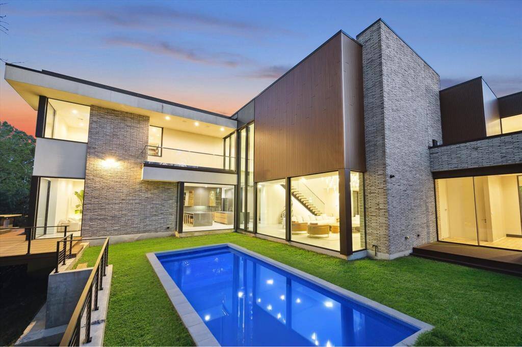 The expansive backyard offers serene views and plenty of room for a future pool, perfect for outdoor relaxation and entertainment. With access from the family room, living room, and primary suite, this space effortlessly connects indoor and outdoor living. POOL IS VIRTUALLY RENDERED.