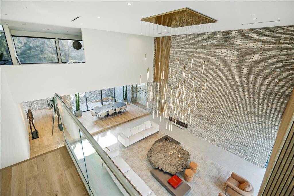 Ascend to the second floor to discover four generously sized guest bedrooms, each with its own ensuite bathroom, along with a spacious game room and a large utility room, providing comfort and convenience for family and guests alike.