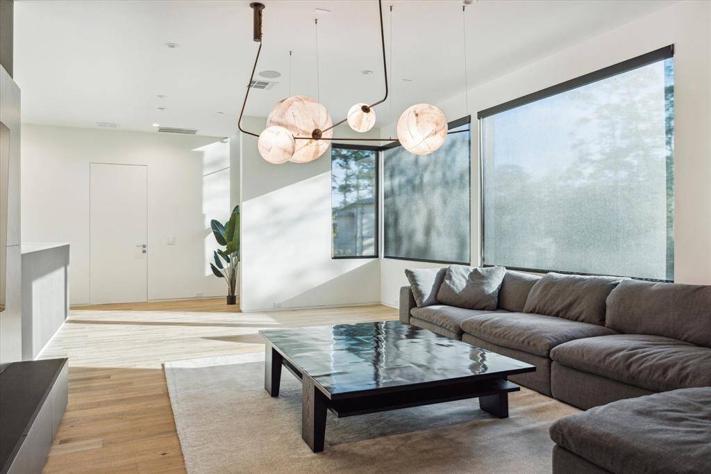 The windows are equipped with remote solar shades, allowing for easy adjustment and optimal light control to suit the space. Additionally, there is ample room for a future chandelier or ceiling fan, offering flexibility to customize the room’s ambiance.