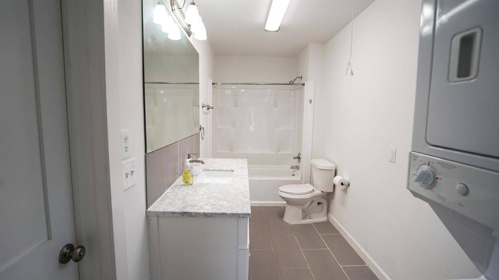 Unit A bath with stacked washer and dryer