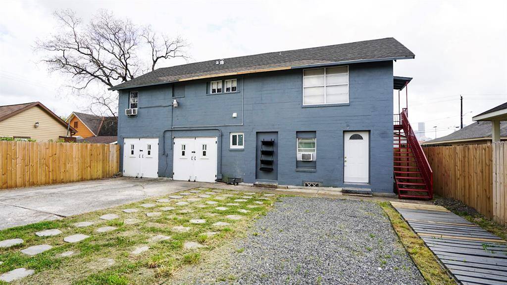 Back building with garage storage area, Unit C 1/1 downstairs and Unit B 3/1 upstairs