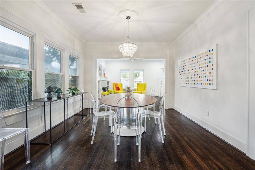 The formal dining room features a stunning crystal chandelier and triple windows that bring in an abundance of natural light.