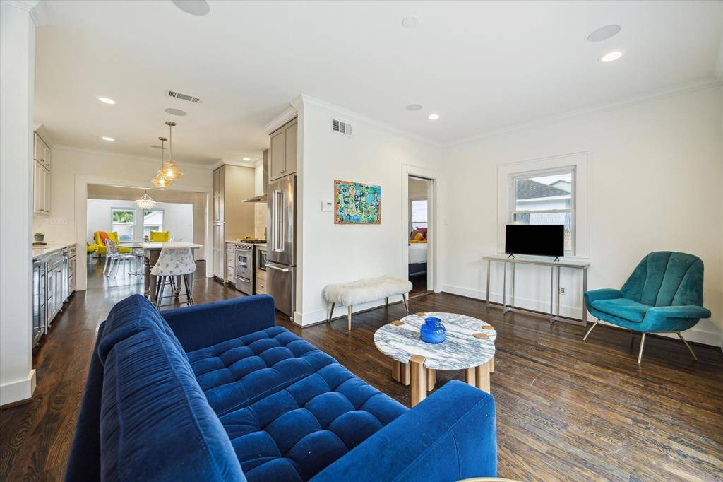 From this angle, you see how the family room flows seamlessly into the kitchen and connects to a back bedroom—perfect for guests or a home office setup.