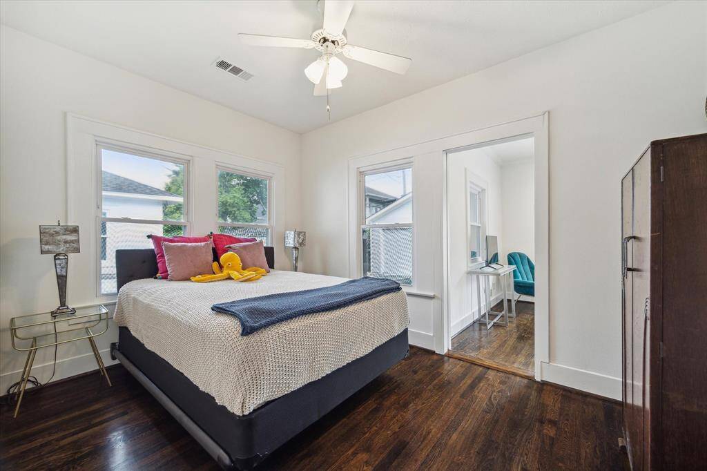 The second bedroom offers charming corner windows and enough space for a queen bed.