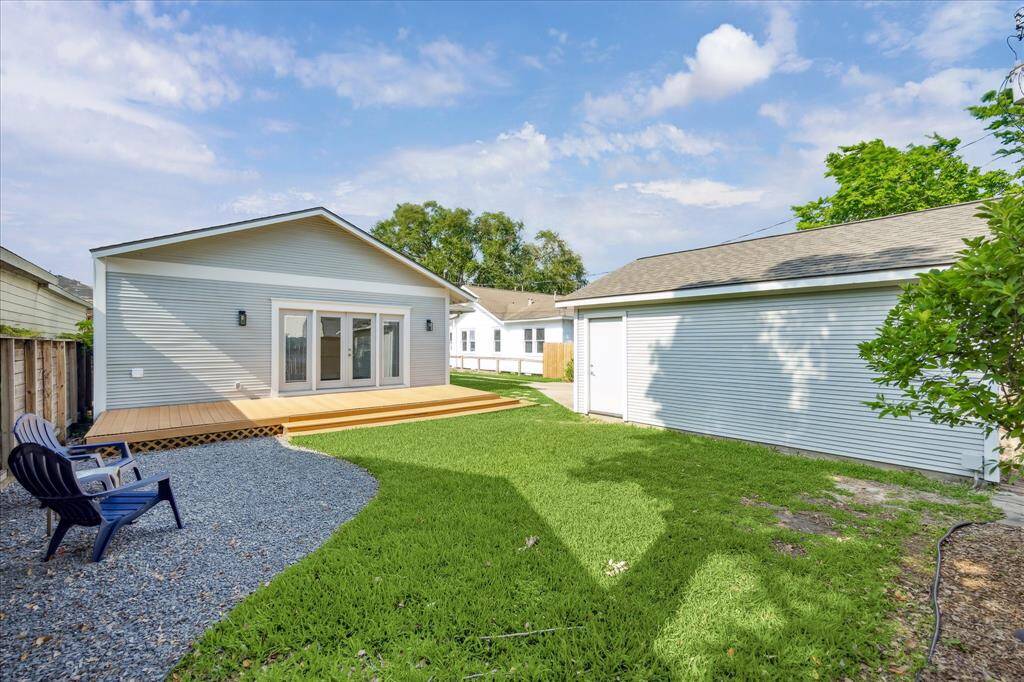 Looking back toward the home, the clean lines of the back elevation and double French doors invite natural light inside while offering direct access to the backyard oasis.