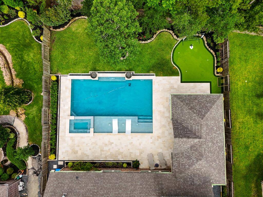 Backyard with pool, spa, outdoor kitchen and a putting green!