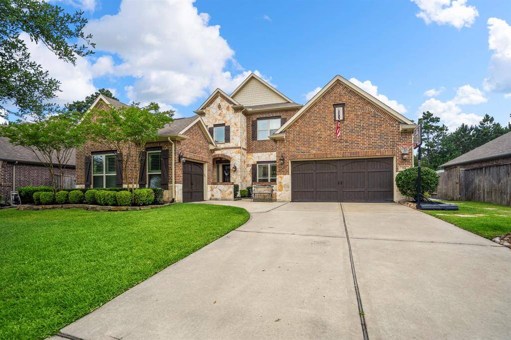 3 car garage and wide driveway for extra parking and front courtyard entryway