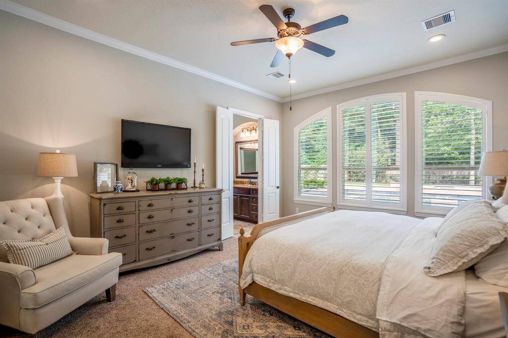 Primary bedroom with large windows and natural light
